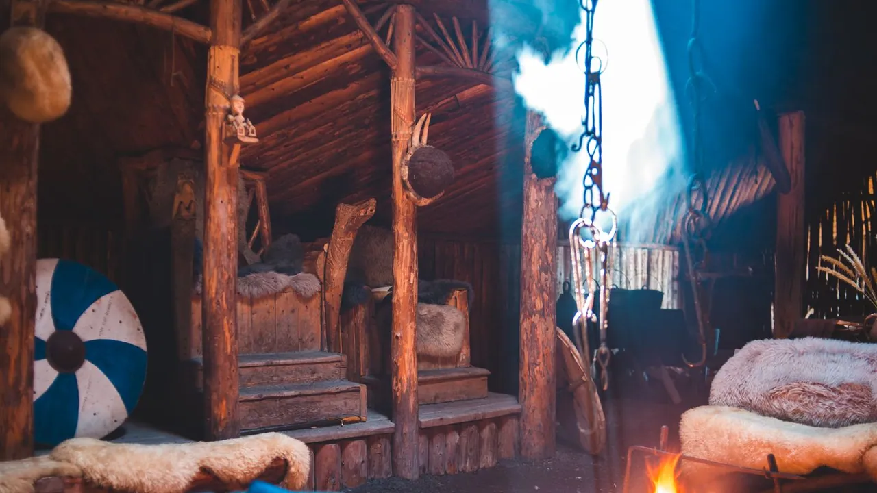A rustic room with wooden beams and a fireplace — the kind of wood surfaces soot settles on
