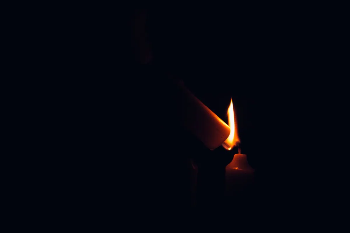 A burning candle flame — the source of the black soot film candles leave on walls and ceilings