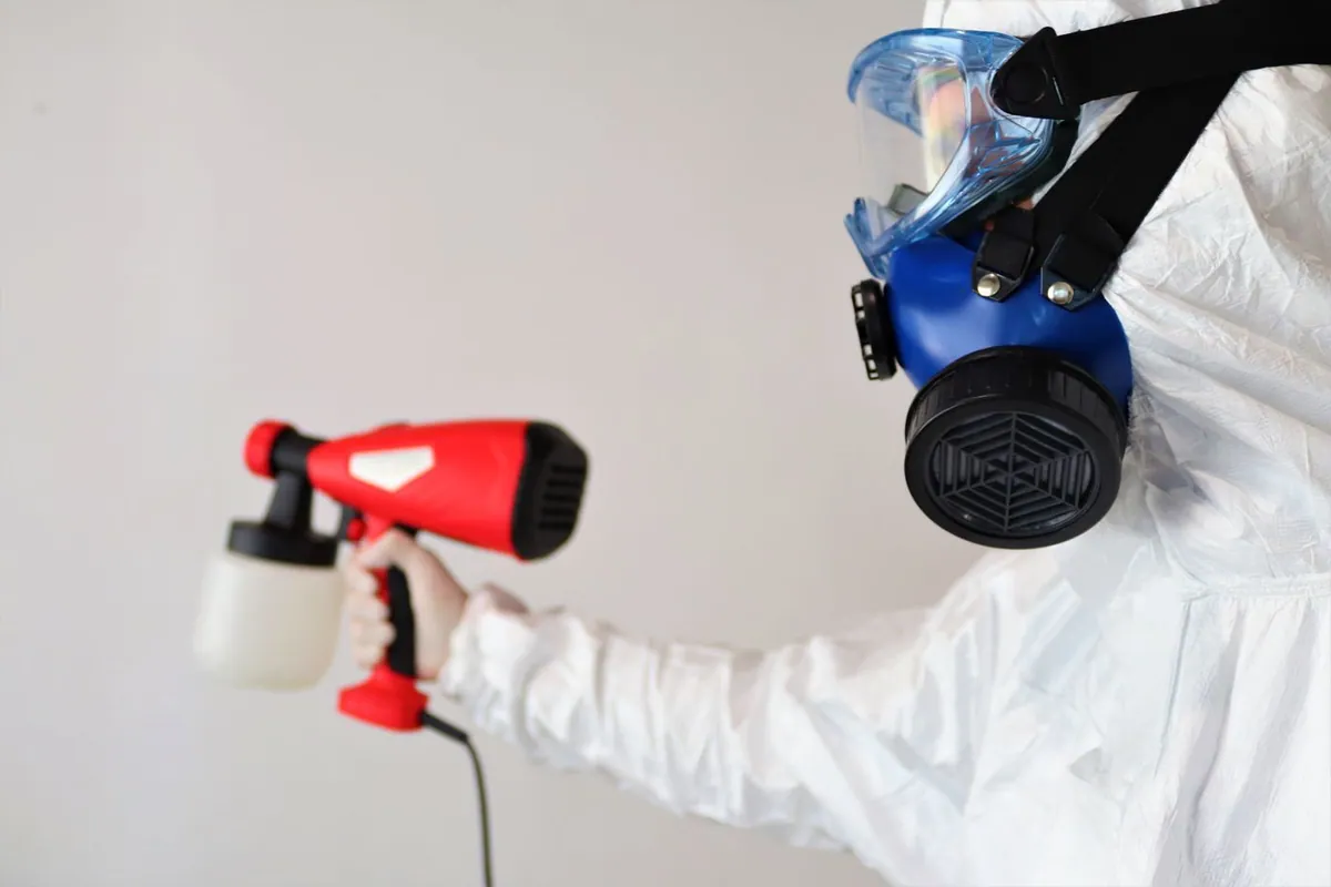 Restoration technician fogging a room to neutralize smoke odor at the source