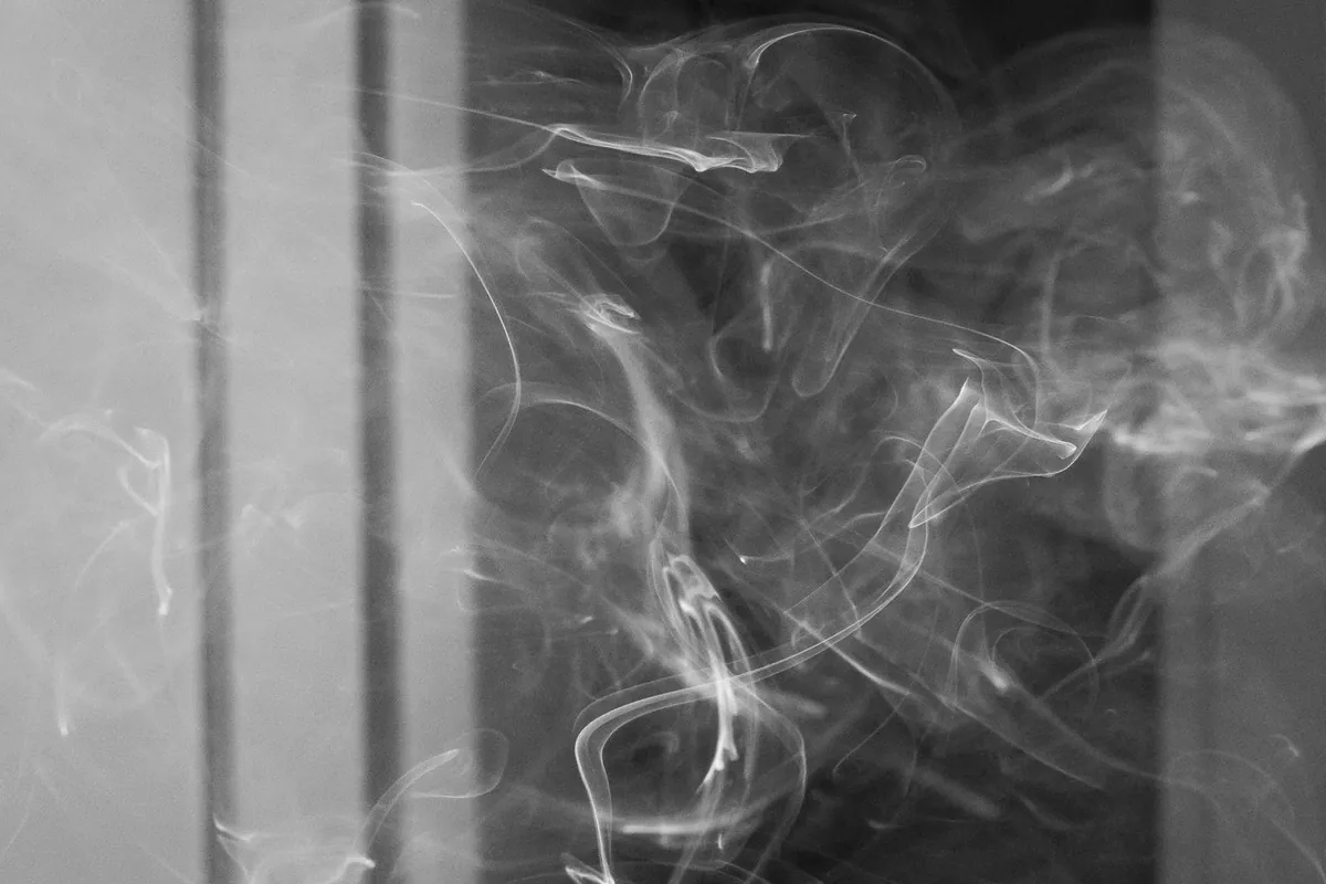 Smoke drifting and settling into surfaces, where odor embeds in walls and drywall